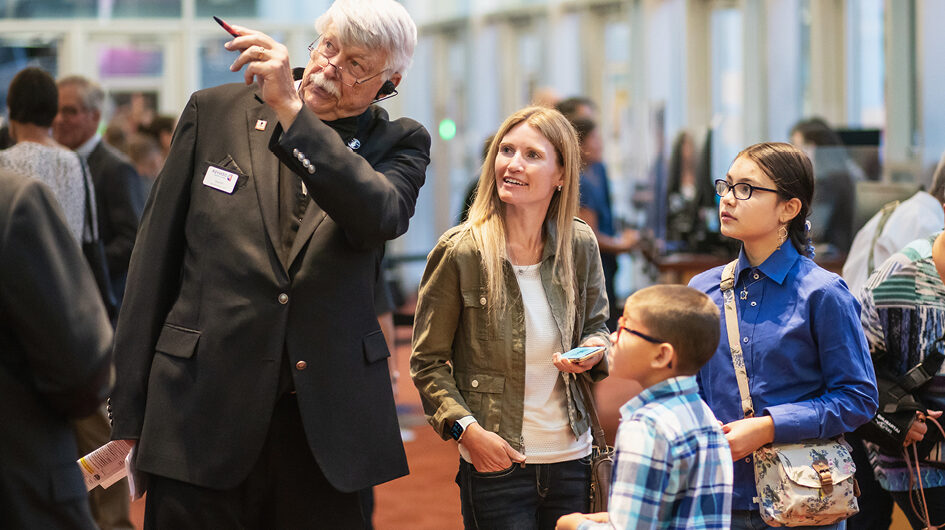 Patrons in the lobby getting help from an Usher