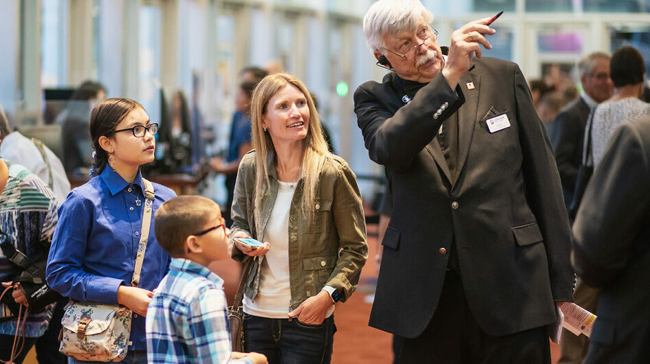 Head Usher assists patrons in the lobby of Boettcher Concert Hall.