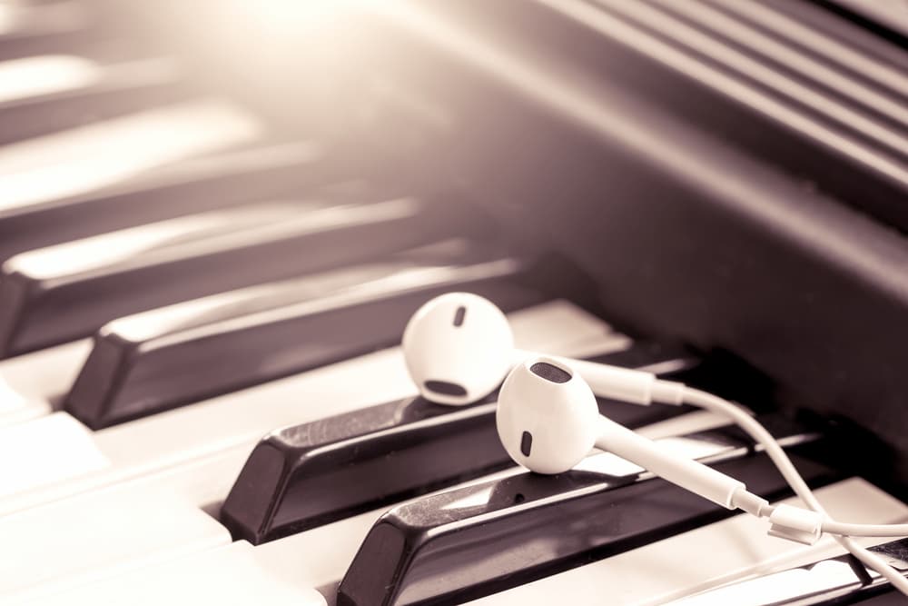 Headphones resting over piano keys