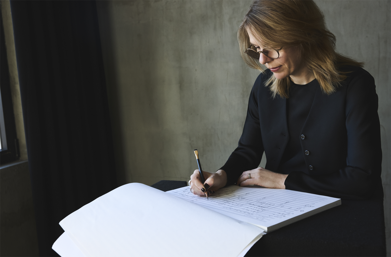 Anna Clyne composing music with pencil and paper - Photo Credit: Victoria Stevens